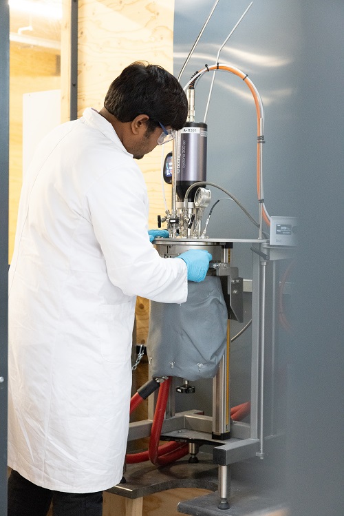 man working with a pressure reactor
